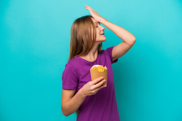 Young Russian woman catching french fries isolated on blue background has realized something and intending the solution