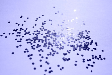 Purple sparkles on a pink background. The concept of celebrating the new year or birthday. Trendy Color of Year 2022.