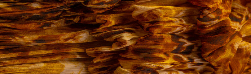 Silk fabric made of fine organza with print imitating panther skin, brown. Texture. Background....