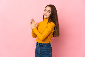 Little girl isolated on pink background scheming something