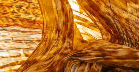 Silk fabric made of fine organza with print imitating panther skin, brown. Texture. Background....