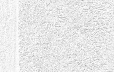 White plaster on the building. Plaster is a building material used for protective or decorative coating of walls and ceilings. After drying off from calcium carbonate, it turns white