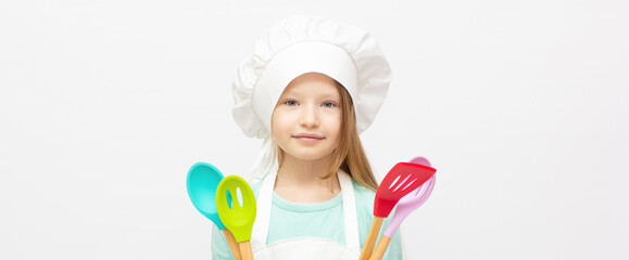 Beautiful little girl in chef uniform isolated on white