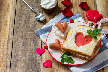 Breakfast for valentine's day or mother's day. Toast with salmon and cheese with the inscription that I love you, on a rustic table.  Copy space.