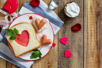 Breakfast for valentine's day or mother's day. Toast with salmon and cheese with the inscription that I love you, on a rustic table.  ​Top view flat lay. Copy space.