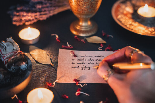 Female Woman Writing A Note In A Cursive Handwriting With A Fancy Gold Fountain Pen. Golden Pen Nib, Black Ink On Aged Old Paper. Candle Light Mood, Cozy Dark Academia Aesthetic. 