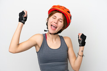Young cyclist English woman isolated on white background celebrating a victory