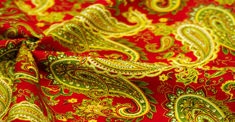 Paisley green pattern on a red background. decorated the bandanas of cowboys and bikers popularized by The Beatles, ushered in the era of hippies and became the emblem of rock and roll. - obrazy, fototapety, plakaty