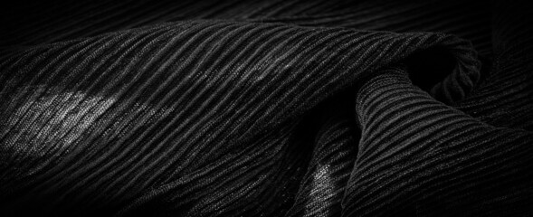 Black crepe is a fabric made of silk, wool or synthetic fibers with a distinctly crisp, ruffled appearance. Texture, background, pattern