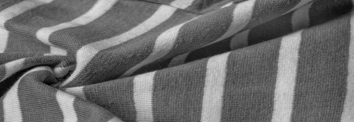 fabric from gray and white woolen stripes, woolen knitwear, which is elegant and pleasant to work with. Great for your projects. Texture, background