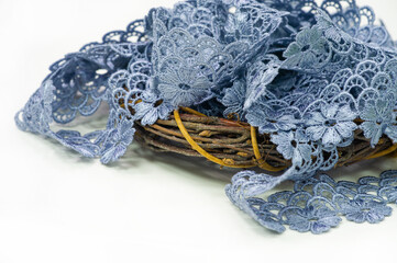 Gray-blue lace ribbon. wide floral pattern, colorful lace fabric, gift wrapping and flower decoration.