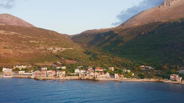 Greece. Mani Laconia, Peloponnese. Limeni port aerial zoom out shot, bay coast and village. Tourist resort, sunny summer day	
