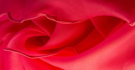 Red silk organza with wavy piping. Border around the edge of the fabric. Abstract background....