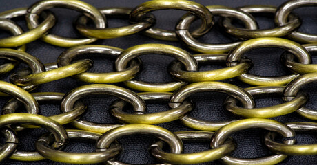 Anodized metal chain, jewelry. The chain is a sequential assembly of connected parts that have a...