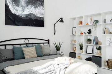 Bed with pillows and shelves with decor