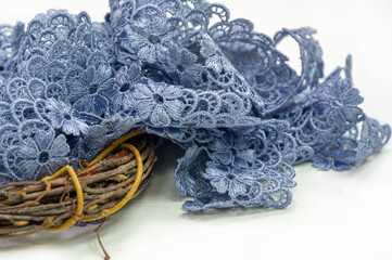 Gray-blue lace ribbon. wide floral pattern, colorful lace fabric, gift wrapping and flower decoration.