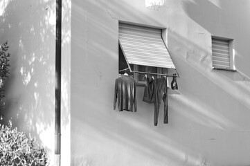 Clothes, towels and bed sheets hanging out of the window to dry (Pesaro, Italy, Europe)