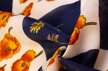 Silk fabric. White and blue squares with floral print. The flowers are    red-yellow. Texture background pattern. From the floral print, the fabric breathes in spring and good mood. - Powered by Adobe