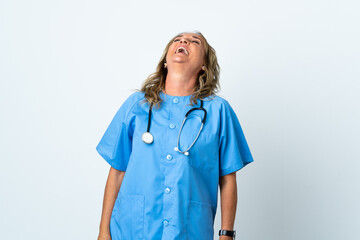 Middle aged surgeon woman over isolated background laughing in lateral position