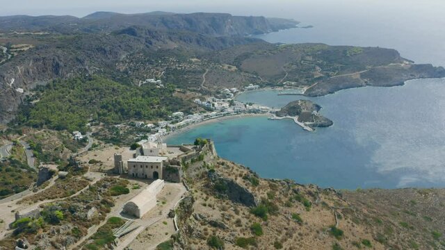 Kythera, Greece. Aerial drone panorama of Chora Venetian castle over Kapsali twin bay coast, harbor beach and village.	