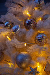 Christmas background: christmas white fir-tree with golden balls and garland