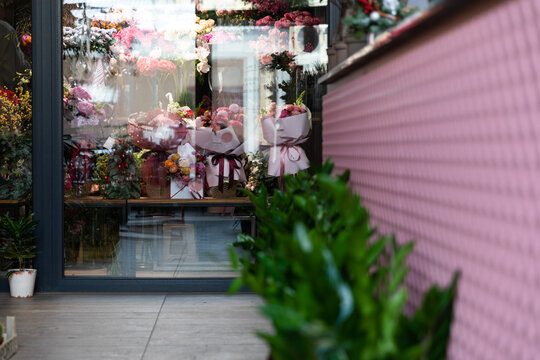 florist shop window with flower arrangements behind glass, photograph with depth of field