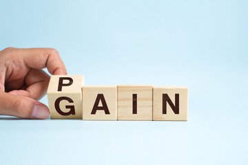 Pain or Gain concept, Hand flip wood cube change the word