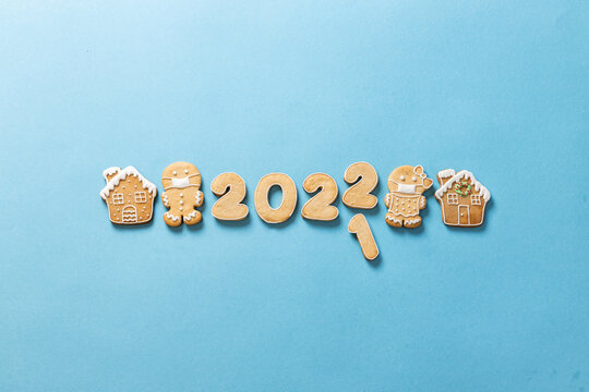 New Years eve 2021/2022 with sugar glazed ginger bread brown winter holiday cookies on sky blue background, happy holidays