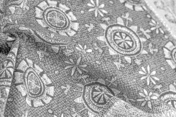 black and white, silk fabric with white drawings of flowers circles. Charmeus has a beautiful drapery. It can be assembled in soft ful. design texture