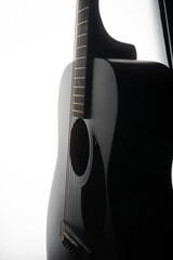 
black and white photo of an acoustic guitar. close-up of a black guitar.
