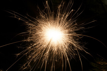 A sparkler shinning in the dark, Orange holiday sparkle fireworks
