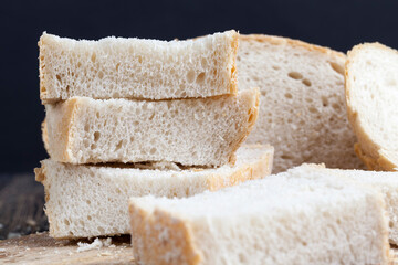 sliced pieces of gray bread from second-rate flour - obrazy, fototapety, plakaty