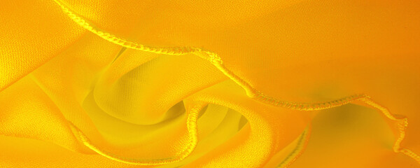 Yellow silk organza with wavy piping. Border around the edge of the fabric. Abstract background....