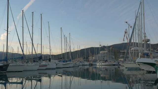 Marina with many boats on a quiet evening. sailboats and motor yachts are moored side by side at sunset