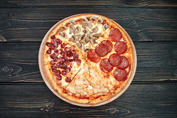 Top view of Pizza Margherita on black background. Classic Italian Pizza Margarita with Tomato sause, Basil and Mozzarella Cheese