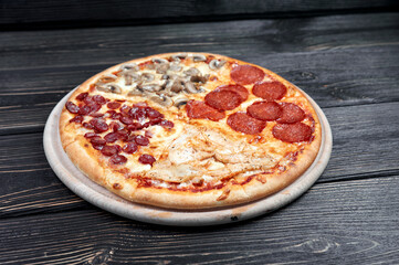 Hot big pepperoni pizza tasty pizza composition with melting cheese bacon tomatoes