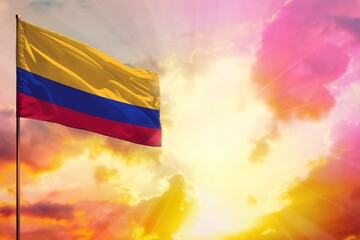 Fluttering Colombia flag in top left corner mockup with the space for your text on beautiful colorful sunset or sunrise background.