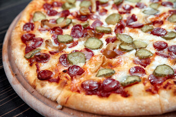 Hot big pepperoni pizza tasty pizza composition with melting cheese bacon tomatoes