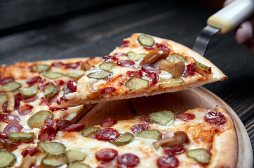 Hot big pepperoni pizza tasty pizza composition with melting cheese bacon tomatoes