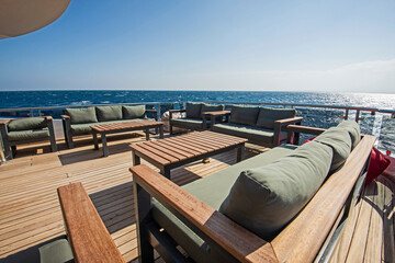 Table and chairs on stern deck of a luxury motor yacht
