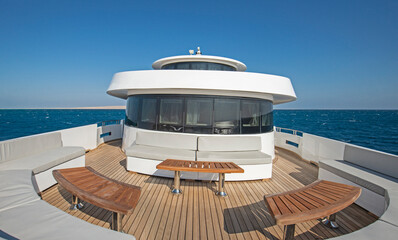 Table and chairs on bow deck of a luxury motor yacht