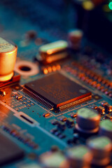 Electronic circuit board with electronic components such as chips close up. Blurry background.	