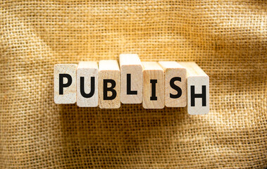Publish symbol. The concept word Publish on wooden blocks. Beautiful canvas background, copy space. Business publish and publishing concept.