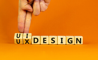 UX user experience design or UI user interface design symbol. Businessman turns cubes, changes words UX design to UI design. Beautiful orange background. Business UX or UI design concept. Copy space.