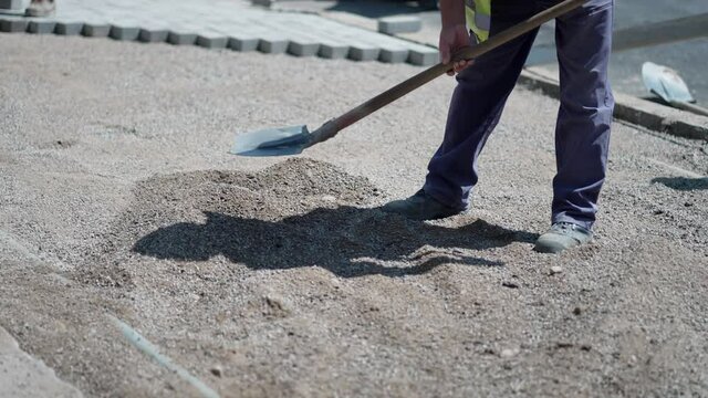 Worker leveling concrete pavement for mix cement at construction site, slow motion