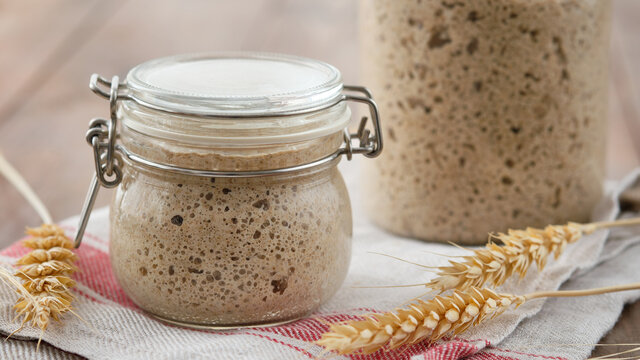 Active rye sourdough starter in a jar. Copy space.