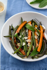 Green beans with carrots cooked with olive oil and sage. Healthy food.