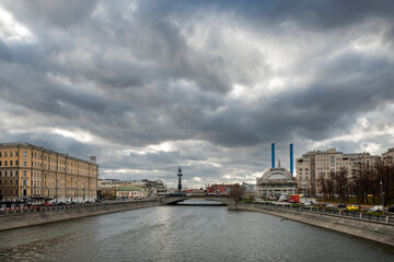 The house on the embankment, the Drainage canal, the Small Stone Bridge, the Udarnik cinema and the blue pipes of HPP-2. Urban autumn landscape