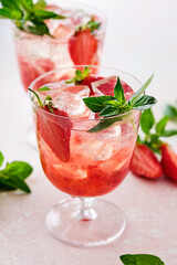 Strawberry cocktail drink with ice and oregano.
