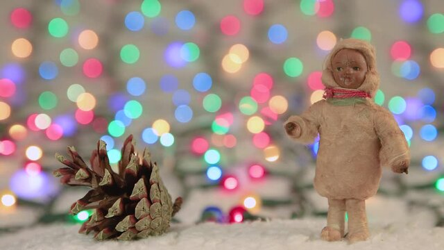 New Year's screensaver dark-skinned girl on the background of Christmas lights. Copy space. Multicolored lights out of focus. Beautiful footage, video for intro, transition, intro. UHD 4K.